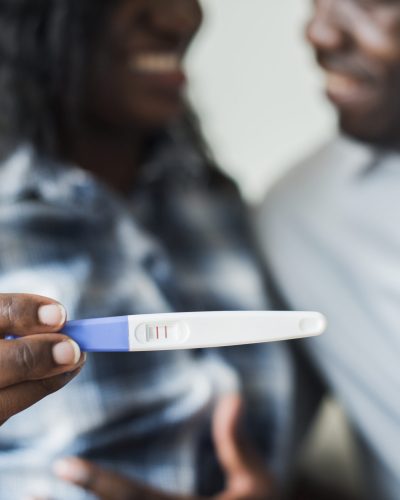 Black couple with a positive pregnancy test result